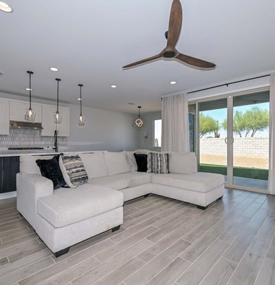 Experience seamless indoor-outdoor flow with this open layout, showcasing upgraded flooring, a statement fan, and sliders to the backyard.