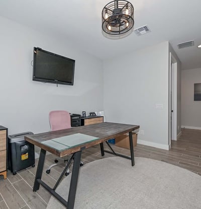 Tucked away for quiet productivity, this smartly designed den offers comfort and style with recessed lighting and modern finishes.