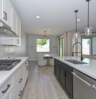 This oversized island with black paneling and quartz counters serves as the focal point, combining elegance and practicality for modern living in Peoria.