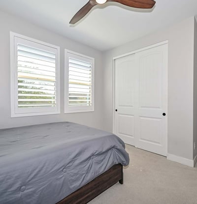This inviting second bedroom offers dual windows, clean finishes, and functional layout ideal for versatile living in Peoria.