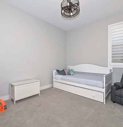 A bright and neutral bedroom with playful touches and room to grow. Use it as a nursery, guest space, or stylish home office.