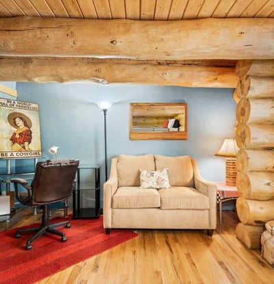 Comfortable bedroom featuring a built-in desk area and seating, offering flexibility for guests, hobbies, or a home office within a rustic setting.