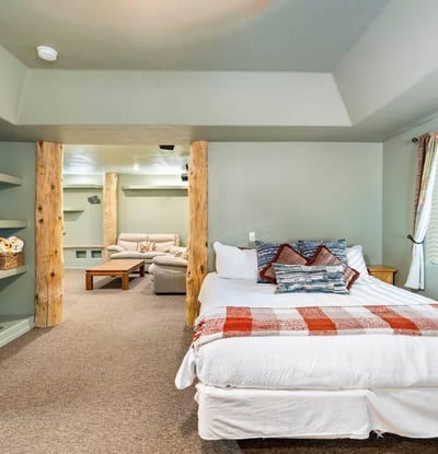 Comfortable bedroom with built-in shelving, neutral tones, and soft lighting for restful nights and organized living.