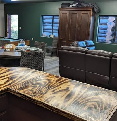 Inviting entertainment room featuring a handcrafted bar, open layout, and space for games or lounging. Designed for comfort and function, this area complements the home s rustic Prescott mountain style.