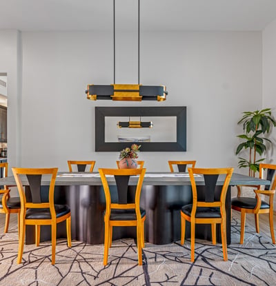 Contemporary dining room with designer lighting, seating for family gatherings, and open flow to the great room in Scottsdale.