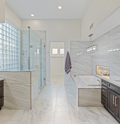 Remodeled primary bath with soaking tub, dual vanities, and spa-inspired shower offers a luxurious retreat.