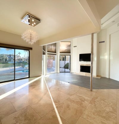 Sun-drenched living area featuring sliding doors to the patio and pool. Perfect for gatherings and relaxed lakefront living.
