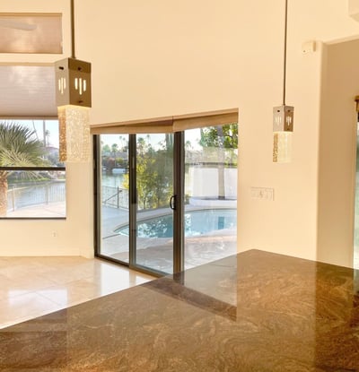 Contemporary kitchen island illuminated by elegant pendant lights, offering abundant space for meal prep and casual dining.