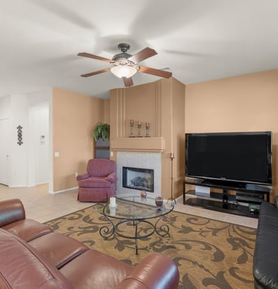 Cozy up by the gas fireplace in this elegant living area. Large windows and earthy tones create a comfortable setting for relaxing evenings at home.