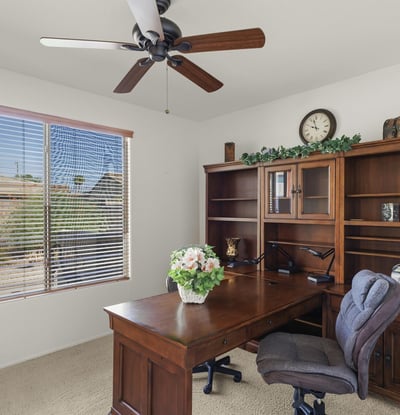 This dedicated office space offers natural light, built-in shelving, and quiet ambiance perfect for working from home in comfort and style.