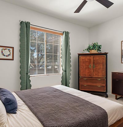 The guest room offers soft light, warm tones, and a peaceful feel ideal for guests or multi-purpose use.