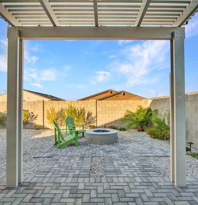 Enjoy mountain views, manicured landscaping, and a peaceful fire pit setting in this beautifully designed Litchfield Park backyard.