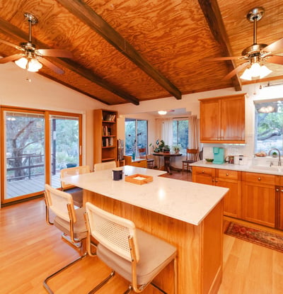 This spacious deck offers the perfect setting for open-air dining and quiet evenings surrounded by mountain views. With multiple seating options and a peaceful desert backdrop, it enhances the home s inviting Hackberry lifestyle.