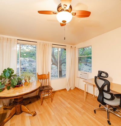 This airy flex space offers panoramic window views and bright natural light, ideal for remote work, plant lovers, or creative pursuits. Warm flooring and peaceful desert scenery enhance everyday comfort.