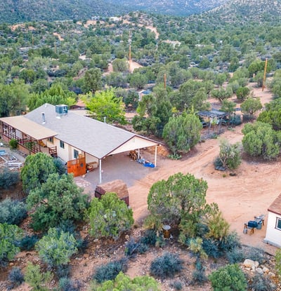 This wide-angle aerial captures the home site, workshop, and abundant surrounding land. Perfect for those wanting both privacy and room to expand in a scenic desert landscape.