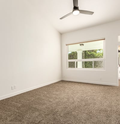 Spacious primary bedroom with high ceilings, plush carpet, and generous natural light. The peaceful Scottsdale setting offers a relaxing retreat with easy access to the updated ensuite bathroom.