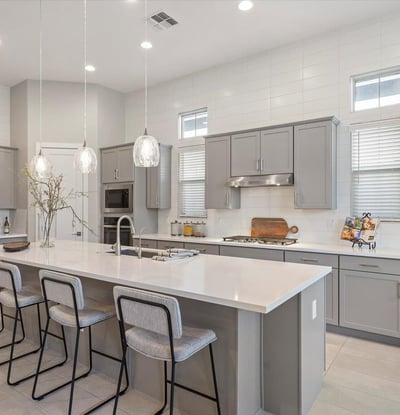 Eye-catching kitchen centerpiece featuring a large quartz island, premium cabinetry, and gas cooktop, ideal for entertaining and everyday cooking.