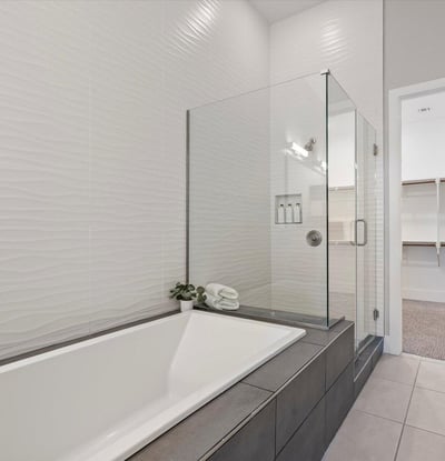 Luxury bathroom escape with soaking tub, glass-enclosed shower, and stylish tile accents for everyday indulgence.