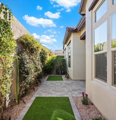 Private backyard featuring artificial turf and low-maintenance landscaping, providing a clean and functional outdoor space.