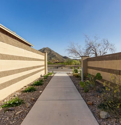 Desert-lined walking trail offering scenic views and a tranquil setting, perfect for enjoying the outdoors within the community.