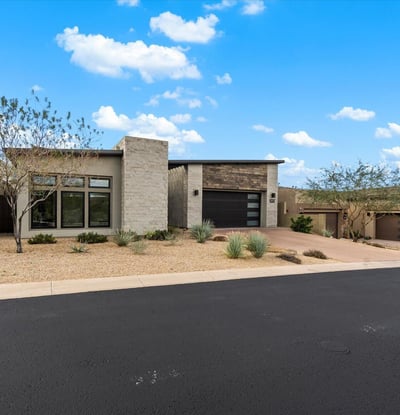 Modern home exterior with minimalist architecture and low-maintenance desert landscaping. Designed for buyers seeking upscale Scottsdale living with strong curb appeal.