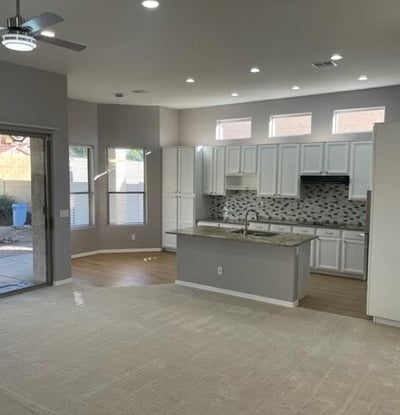 Open kitchen and dining area with direct backyard access, recessed lighting, and updated finishes for seamless indoor-outdoor living.