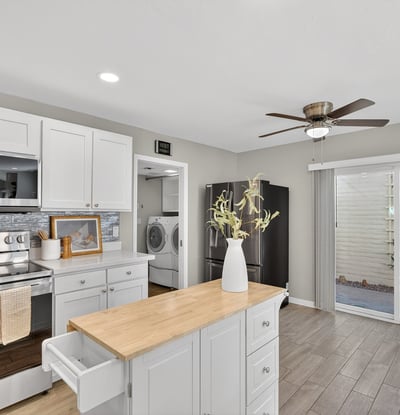 Functional kitchen with island workspace, modern finishes, and easy access to dining and living areas for seamless daily living.