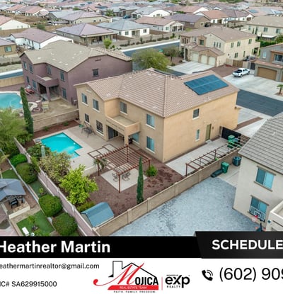 Rear aerial perspective displays the full backyard oasis with covered patio and pool. Solar panels provide energy efficiency, making this Glendale home both stylish and practical.