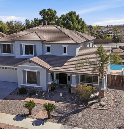 Drone perspective highlighting the beautiful Queen Creek home with a private pool and spa backyard, desert landscaping, and spacious lot within the desirable Cortina neighborhood.