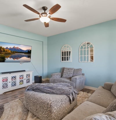 Front living room featuring soft natural light, updated flooring, and comfortable seating space perfect for relaxing or welcoming guests.