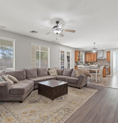 Expansive great room that flows into the kitchen and dining areas, highlighting the open floor plan that makes this Queen Creek home perfect for modern living.