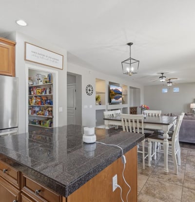 Functional kitchen featuring granite countertops, stainless steel appliances, and center island with seating, perfect for meal prep and casual dining.