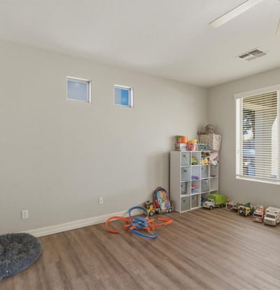Spacious bonus room with wood-style flooring and natural light, offering flexible space for a playroom, office, or additional living area.