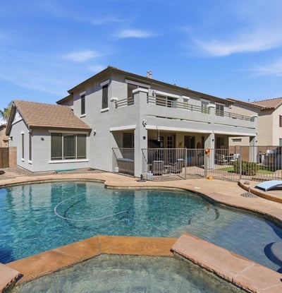 Resort-inspired backyard with freeform pool, raised spa, and spacious decking ideal for relaxing, swimming, and entertaining guests.