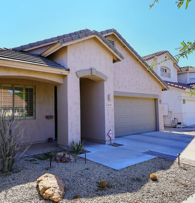 Angled exterior view highlighting the home s design, landscaping, and driveway. This Phoenix property offers appealing curb presence.