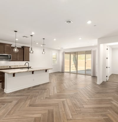 Large open great room with designer tile flooring and recessed lighting, offering a seamless layout for entertaining and modern living.