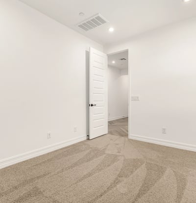 Bright bedroom featuring neutral finishes, soft carpet, and energy-efficient window coverings for a comfortable atmosphere.