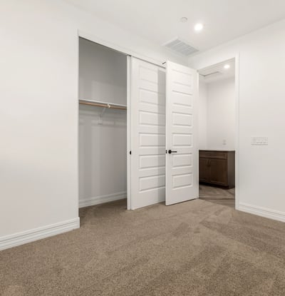 Bedroom with built-in closet and neutral design, providing flexible living space and organized storage options.