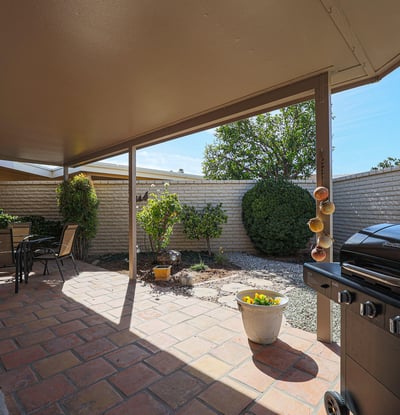 Covered patio with paver flooring and outdoor seating area, ideal for enjoying Arizona-style indoor-outdoor living.