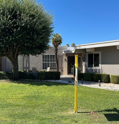 Well-maintained Sun City exterior with vibrant grass, mature landscaping, and a peaceful front approach that enhances the home s curb appeal and overall charm.