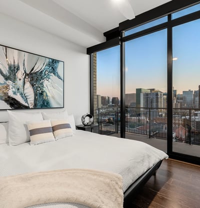 Inviting secondary bedroom with large windows, natural light, and clean modern finishes, perfect for guests or home office use.