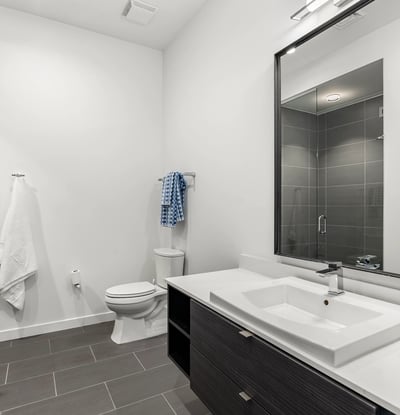 Modern guest bathroom featuring a glass walk-in shower, updated fixtures, and clean contemporary finishes in this Phoenix property.
