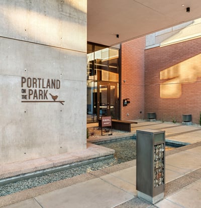 Modern building entrance featuring a sleek water feature, secure access, and updated finishes in Phoenix.
