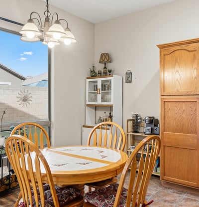 Cozy dining space with large window and backyard views, offering a bright and welcoming setting for meals in this Phoenix home.