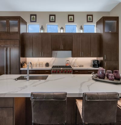 High-end kitchen featuring a Wolf gas range, custom cabinets, and quartz surfaces, perfect for culinary enthusiasts in this Phoenix home.