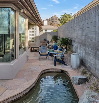 Peaceful outdoor space with a water feature, patio seating, and scenic views, offering relaxation in this Phoenix property.