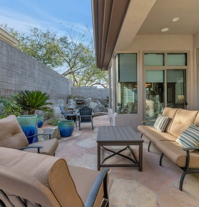 Spacious covered patio featuring sliding glass doors for seamless indoor-outdoor living in this Phoenix home.