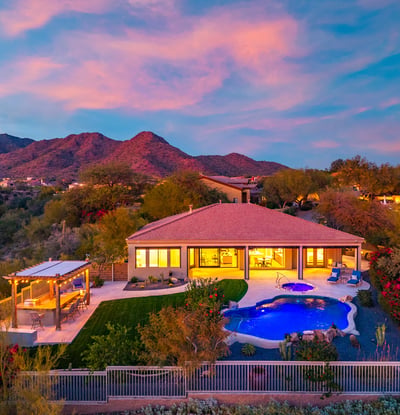 Stunning backyard retreat featuring pool, spa, pergola, and lush lawn, designed for Scottsdale outdoor living with panoramic mountain scenery.