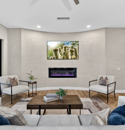 Contemporary Scottsdale living room showcasing a sleek fireplace, neutral tones, and updated finishes, creating a comfortable and stylish gathering space.
