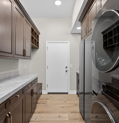 Functional Scottsdale laundry area with upper cabinets, utility sink, and durable countertops for everyday use.